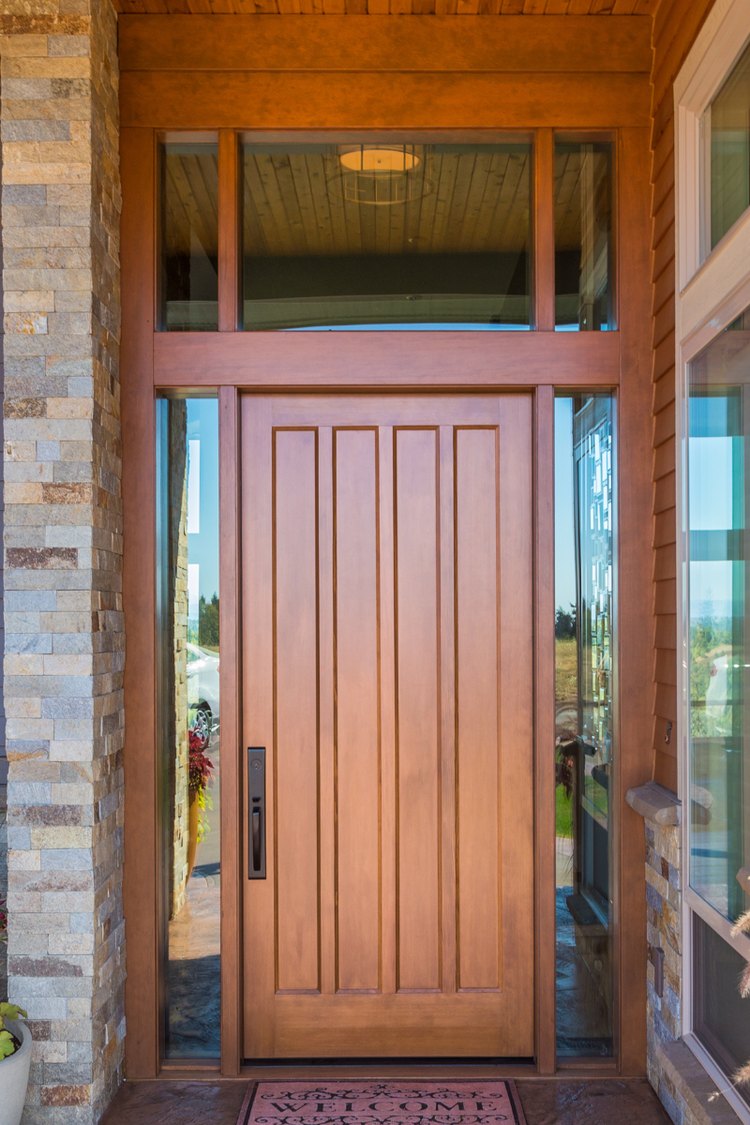 Wood front door with glass transom and sidelight