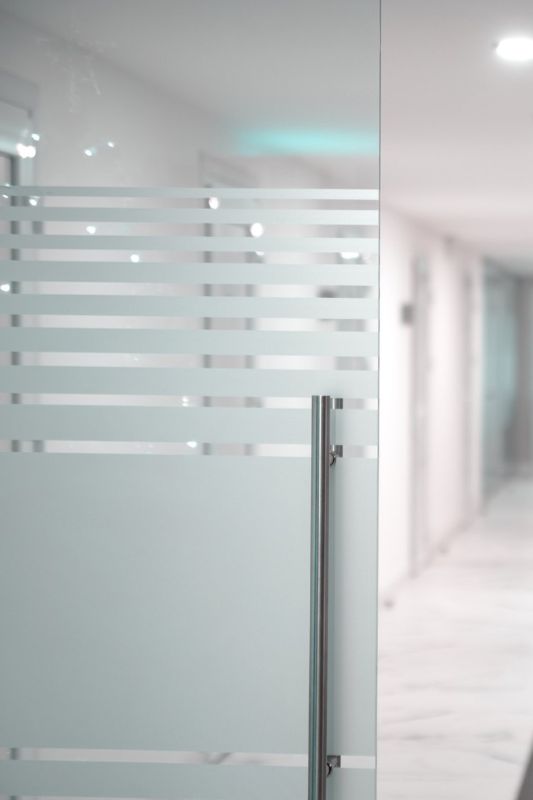 Frosted stripe Herculite glass door in an office hallway