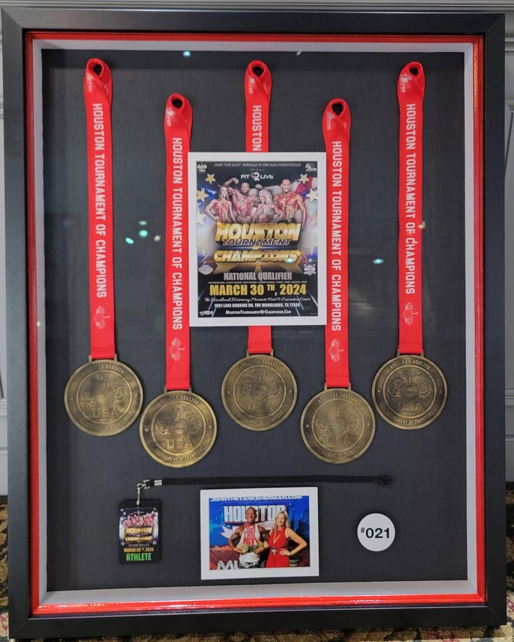 Shadow box displaying race medals and a photo