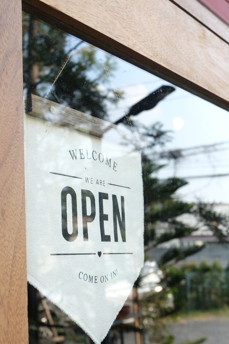 Storefront glass door with an open sign