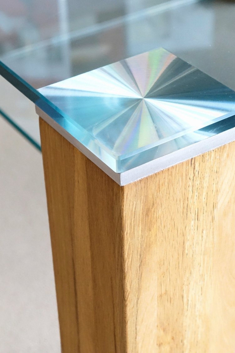 Beveled glass table top edge on a wood base